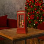 Cabina telefónica navideña con figura de Santa Claus